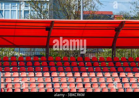 The stadium is empty, with a row of red seats lined up in a row Stock Photo