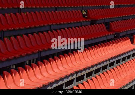 The empty seats are red and arranged in rows. Concept of emptine Stock Photo