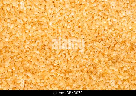 Brown cane sugar crystals  close up. Food background. Stock Photo
