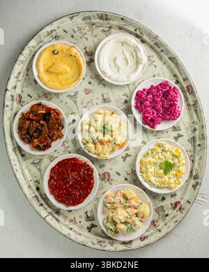 Assorted western salads corn salad with mayonnaise red cabbage salad Russian salad picante salad mayonnaise salad pasta salad with mayonnaise eggplant Stock Photo