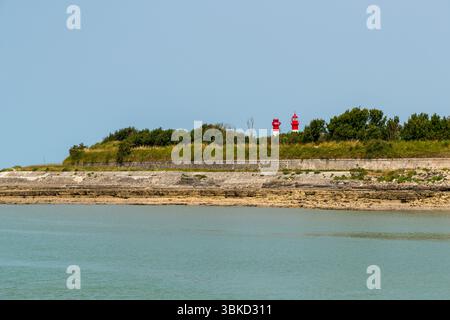 Fortifications on the island of Aix with the island's two lighthouses. The lighthouses were used to guide ships safely through the shallow and sometimes dangerous waters around the island. As access to the Rochefort naval arsenal had to be well protected and controlled, several strategic light points were set up. Île-d'Aix, Nouvelle-Aquitaine, France Stock Photo