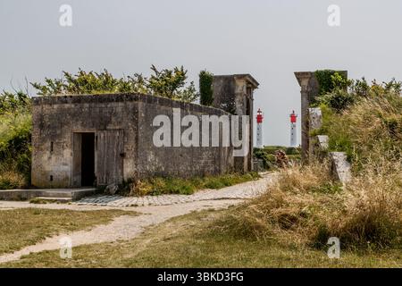 View through the fortification wall around the village of Le Bourg towards the two lighthouses on the island of Aix. Rue Marengo, Île-d'Aix, Nouvelle-Aquitaine, France Stock Photo