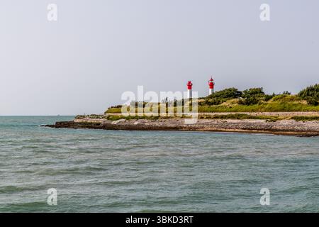 Fortifications on the island of Aix with the island's two lighthouses. The lighthouses were used to guide ships safely through the shallow and sometimes dangerous waters around the island. As access to the Rochefort naval arsenal had to be well protected and controlled, several strategic light points were set up. Accès Embarquement, Île-d'Aix, Nouvelle-Aquitaine, France Stock Photo