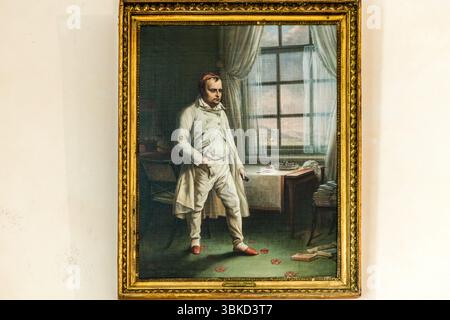 Painting depicting Napoleon under arrest in the governor's house on the island of Aix. The red shoes in the picture can now be seen in the exhibition at the Napoleon Museum. Rue Napoléon, Île-d'Aix, Nouvelle-Aquitaine, France Stock Photo