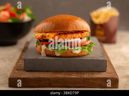 Classic chicken burger with cheese lettuce and sauce. Stock Photo