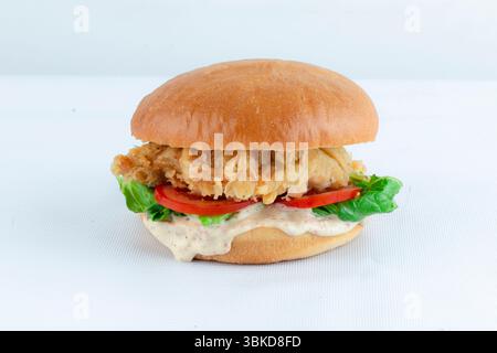 Crispy burger crispy chicken burger with sauce and vegetables isolated on white background. Stock Photo