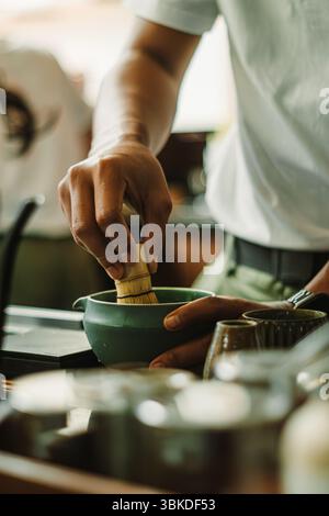 Hands whisking matcha. A traditional Japanese green tea. The calming ...