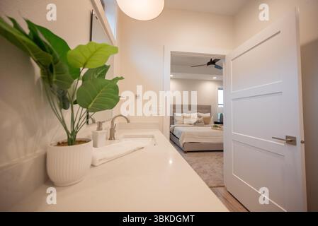 Modern Bathroom Interior with View into Cozy Bedroom Stock Photo