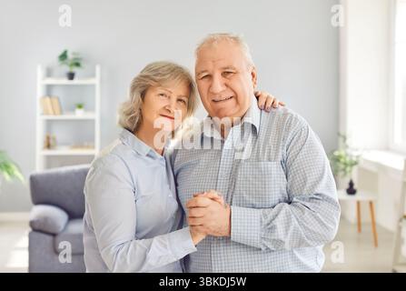 Senior couple portrait, close sincere bonding happy aged old married couple cuddling Stock Photo