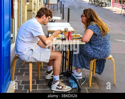 Young couple eating light lunch on bistro outdoor terrace on the rue Colbert, Tours, Indre-et-Loire (37), France. Stock Photo