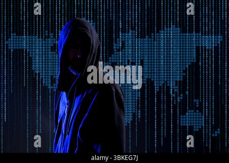 Cyber attack. Anonymous hacker against virtual world map and binary code Stock Photo