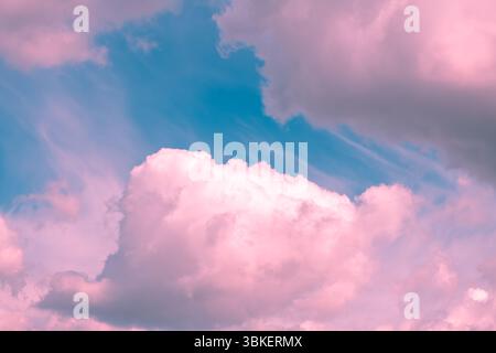 Pink and turquoise hues blend seamlessly in a sky filled with wispy cirrus clouds and fluffy cumulus formations, creating a dreamy and ethereal atmosp Stock Photo