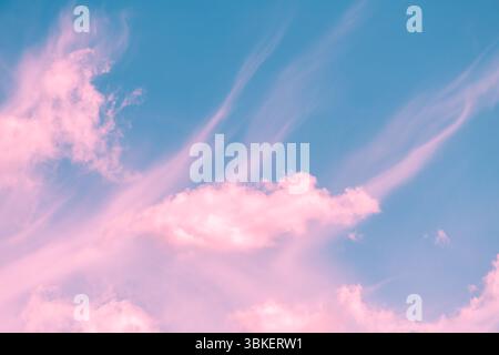 Pink and turquoise hues blend seamlessly in a sky filled with wispy cirrus clouds and fluffy cumulus formations, creating a dreamy and ethereal atmosp Stock Photo