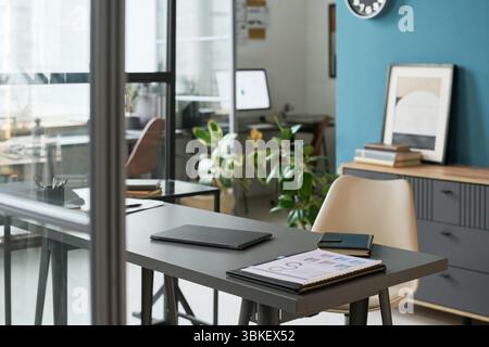 Modern Retirement Studio Office Interior Featuring Desk and Digital Devices Stock Photo