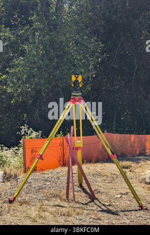 Surveyor equipment on tripod at construction site Stock Photo