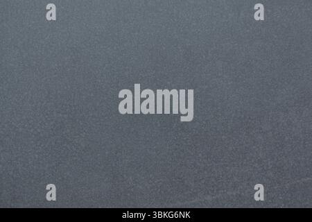 Textured grey surface is filling flat design canvas, showing subtle granular patterns throughout Stock Photo