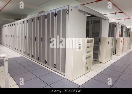 Server cabinet row is lining flat design data center corridor, showing doors and control panels Stock Photo