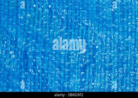 Blue woven plastic tarp texture close-up full frame. Stock Photo