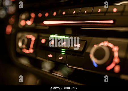 Close up view of illuminated climate control panel in vehicle, highlighting temperature and airflow adjustments Stock Photo