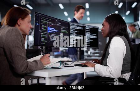 Tech-savvy African Engineer Developing Innovative Software With Diverse Team. Stock Photo