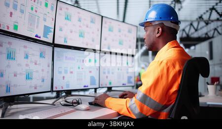 African-American Engineer Monitors Plant Process Using Modern SCADA Technology. Stock Photo