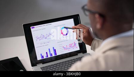 Analyzing Business Data: Young African American Man At Office Stock Photo