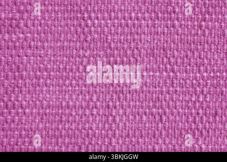 Texture of pink natural fabric with large weaving. Surface, structure of upholstery or carpet material, cloth background close up. Stock Photo