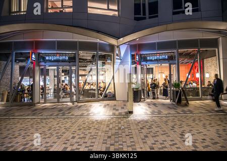 London, UK - September 14, 2023: Wagamama exterior logo, a popular British chain of pan asian restaurants based on Japanese food in Battersea at night Stock Photo