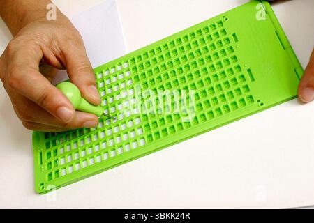 instrument to write in braille on white background Stock Photo