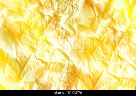 Crumpled paper is being shown in flat design with transparent background, yellow gradient, speckles Stock Photo