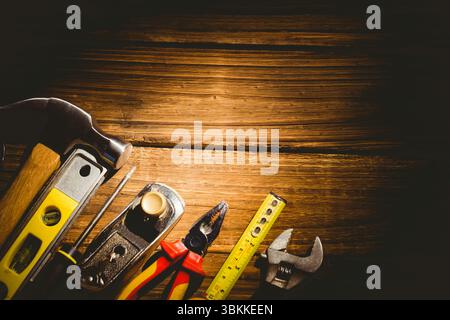 Flat design showing hand tools aligning left on wooden workbench with warm lighting, showing grain Stock Photo
