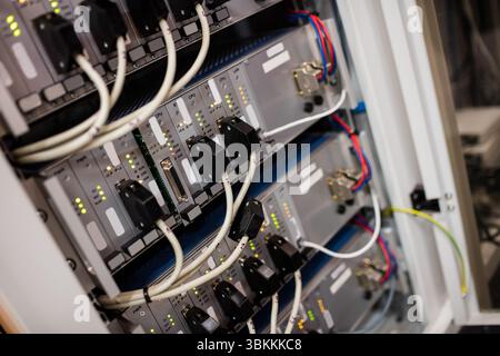Showing flat design cabinet featuring mounted modules looping data cables LED lights cable clips Stock Photo
