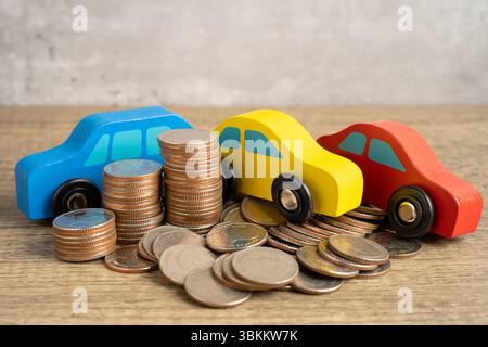 Car on stack of coins. Car loan, Finance, saving money, insurance and leasing time concepts. Stock Photo