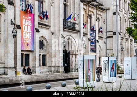 Angoulême town hall with French flags and banners advertising events, including the ‘Festival Musiques Métisses’ and the ‘Festival Limo Photogaphique’. The city is recognized as a UNESCO Creative City in the category of literature since 2019. Place de l'Hôtel de ville, Angoulême, Nouvelle-Aquitaine, France Stock Photo