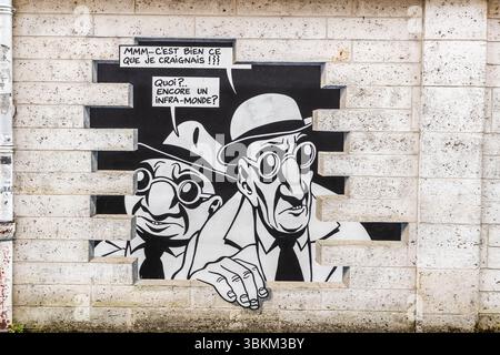 The mural from the series "Réalité, Sortie de Secours" (Reality, Emergency Exit), designed by Marc-Antoine Mathieu, depicts comic book characters with speech bubbles that appear to be bursting out of the wall, Rue de Beaulieu, Angoulême, Nouvelle-Aquitaine, France. In this panel, two men in hats and round glasses look worriedly through the gap in the wall. The speech bubbles read "Mmm... c'est bien ce que je craignais !!?" and "Quoi?.. Encore un infra-monde?" In English: 'Hmm... it's exactly what I feared!' – 'What? Another underworld?' In six panels, the series tells a complete story: "Do you Stock Photo