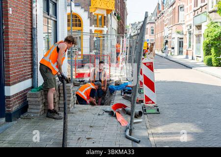 Roadworks on Electrical Lines. Group of Road Workers perform Repairs on Damaged, Electrical Lines, down town Tilburg, Netherlands. Tilburg Tuinstraat Noord-Brabant Nederland Copyright: xGuidoxKoppesxPhotox Stock Photo