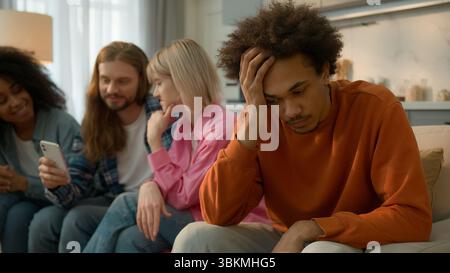 African American sad pensive thinking troubled problem frustrated man guy male at home separated ignore multiracial Caucasian multiethnic friends Stock Photo