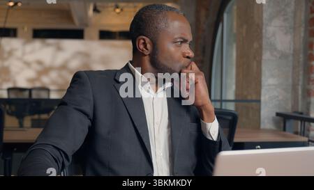 Thoughtful thinking African American adult manager male worker guy think solution ponder decision find answer come up idea plan in office ethnic Stock Photo