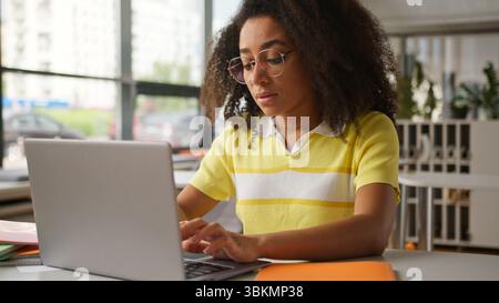 Tired bad unwell ill stressed African American woman girl student female problem headache migraine eyestrain eyes discomfort take off glasses health Stock Photo
