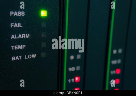 Green light is lit up on a black box that says PASS. The box also has a red light on it that says FAIL Stock Photo