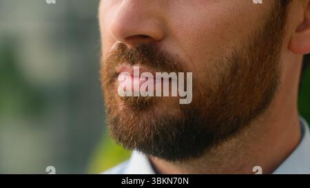 Close up cropped view Caucasian half face mouth lips calm serious unrecognizable European bristle bearded man bristle bearded skin medicine Stock Photo