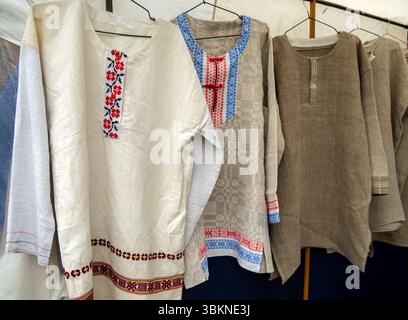 Lipetsk, Russia - May 11, 2024: Traditional Russian linen shirts embroidered with patterns. Rusborg Historical Reconstruction Festival Fair Stock Photo