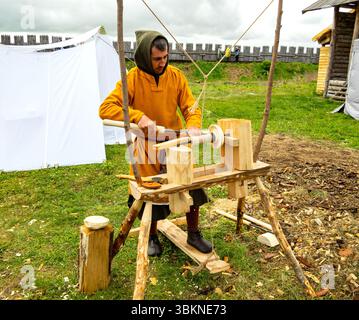 Lipetsk, Russia - May 11, 2024: The process of working on a replica of a medieval lathe. Historical reconstruction festival "Rusborg" Stock Photo
