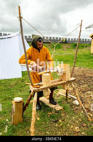 Lipetsk, Russia - May 11, 2024: A master works on a medieval lathe. Historical reconstruction festival "Rusborg" Stock Photo