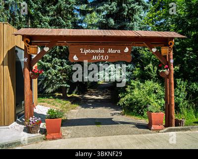 Wooden entrance gate with the sign "Liptovská Mara – Molo" at Dechtáre Pier on Liptovská Mara Stock Photo