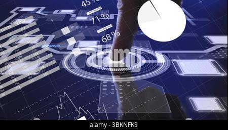 Tapping mid adult male hand selecting square button on dial at holographic display, with charts Stock Photo