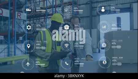 Reviewing colleagues analyzing AR data overlays in warehouse with pallet jack, using devices Stock Photo