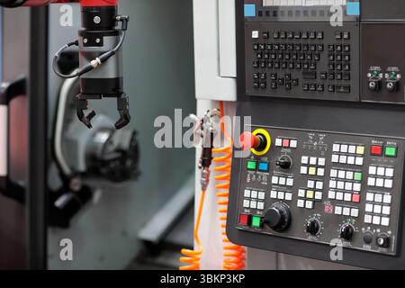 Cobot gripper and CNC lathe machine. Machine tending with collaborative robot or cobot. Automation of placing parts into CNC lathe machine with cobot. Stock Photo