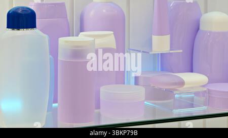 Row of bottles and containers of various sizes and shapes are lined up on a counter. The bottles are all purple and some are clear Stock Photo