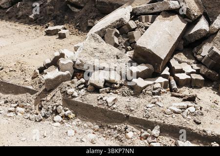 Construction rubble with broken concrete and stones. Demolition waste from destroyed building. Heavy debris texture for recycling concept. Stock Photo